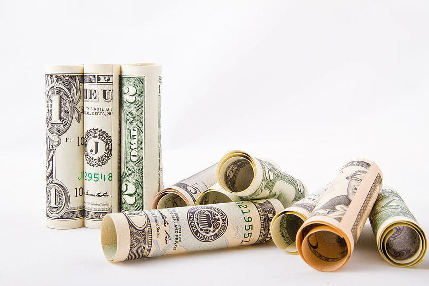 Rolled US Dollar Bills on White Background