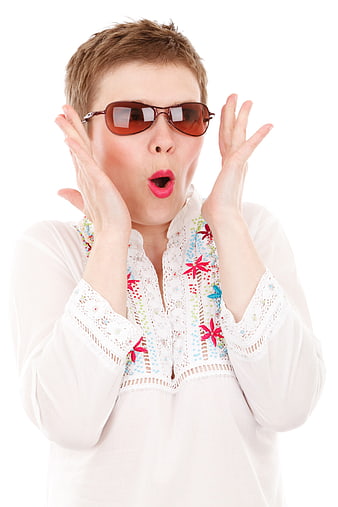 Surprised woman with short hair wearing sunglasses and white blouse