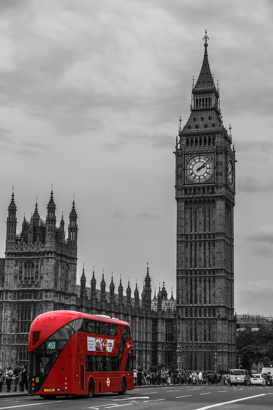 Red Double Decker Bus Passing Big Ben in London
