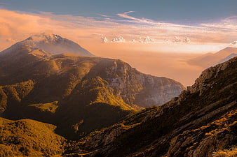 Majestic Mountain Landscape with Golden Sunset and Clouds