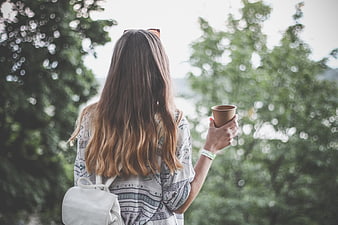 Woman with Coffee Cup Looking at Scenic View