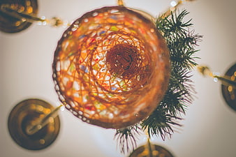 Close-up of woven Christmas ornament with pine branch