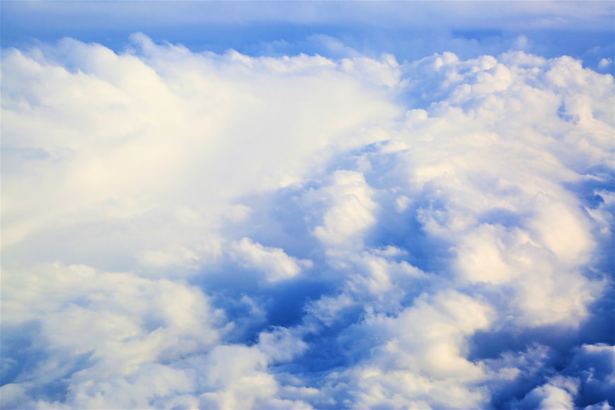 Aerial View of Fluffy White Clouds in Blue Sky