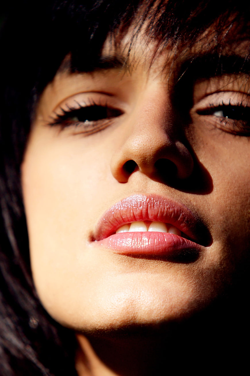 Close-up portrait of a woman's face with dramatic lighting