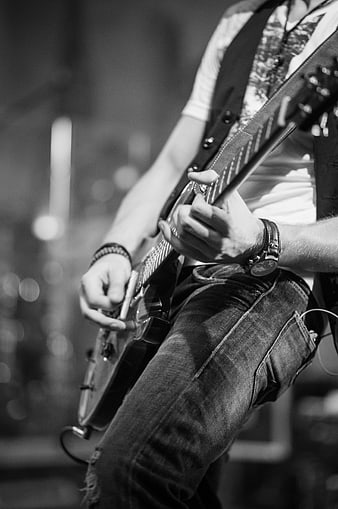 Black and white close-up of musician playing electric guitar
