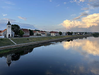 Scenic River Cityscape with Church and Cloud Reflections