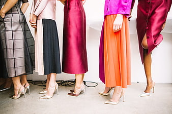 Colorful fashion models wearing high heels and long skirts