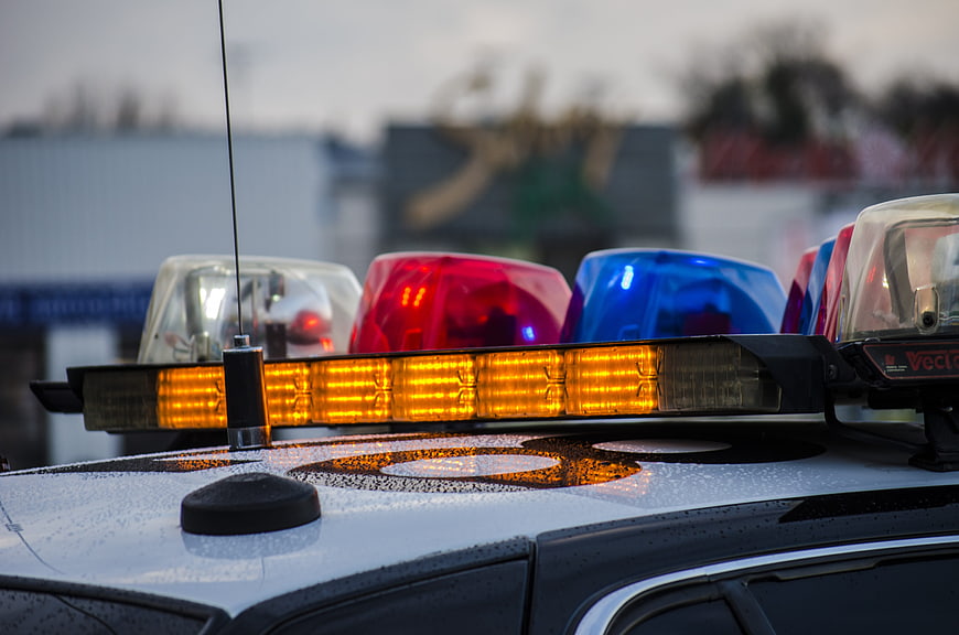 Close-up of police car emergency lights on wet roof