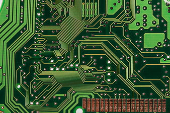 Close-up of green printed circuit board with copper traces