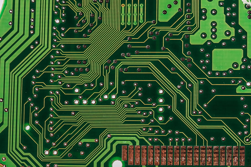 Close-up of green printed circuit board with copper traces