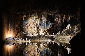 Fairy Grottoes Cave Interior With Stalactites And Water Reflection