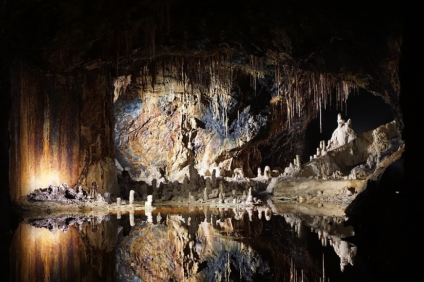 Fairy Grottoes Cave Interior With Stalactites And Water Reflection