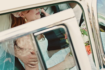 Bride in Vintage Car with Bouquet