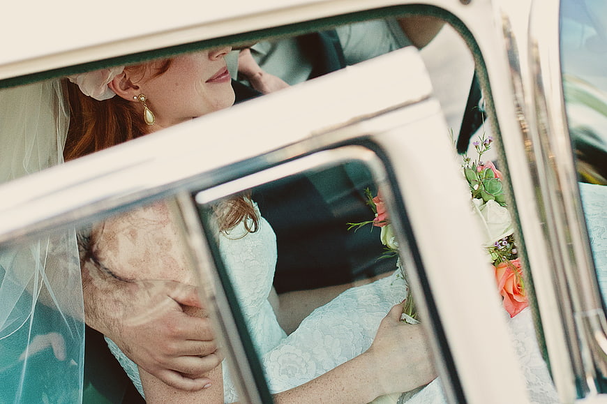 Bride in Vintage Car with Bouquet