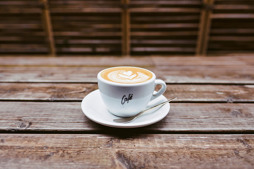 Latte Art Coffee Cup on Rustic Wooden Table