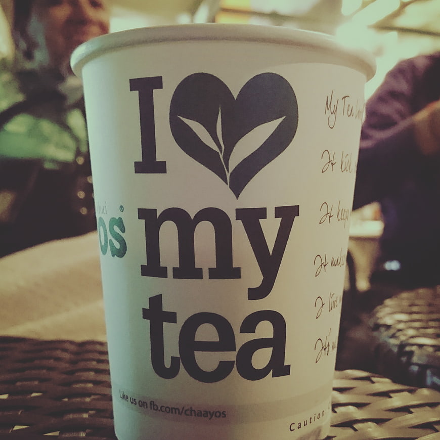 Close-up of paper tea cup with I love my tea text