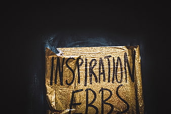 Gold paper sign with handwritten text inspiration ebbs