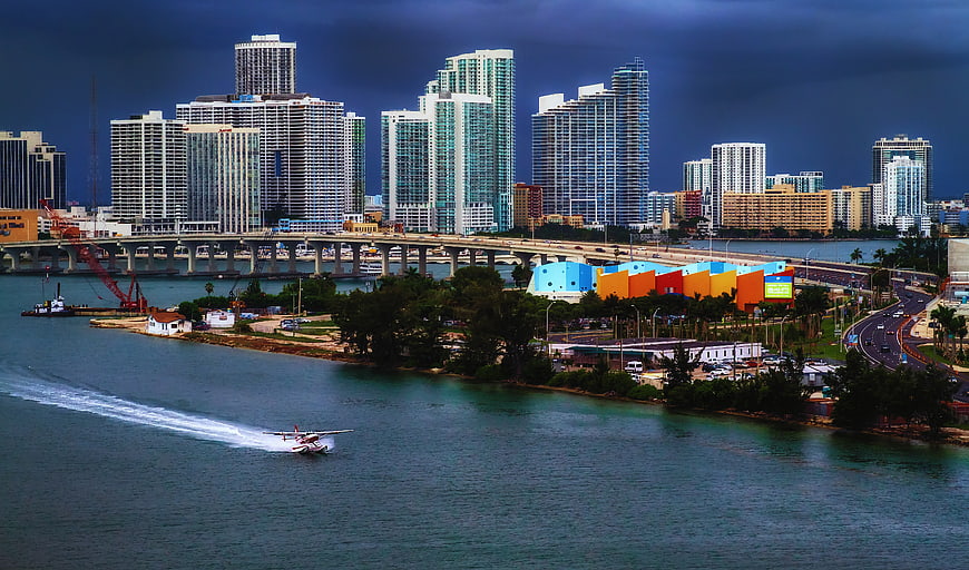 Miami skyline with seaplane landing on water