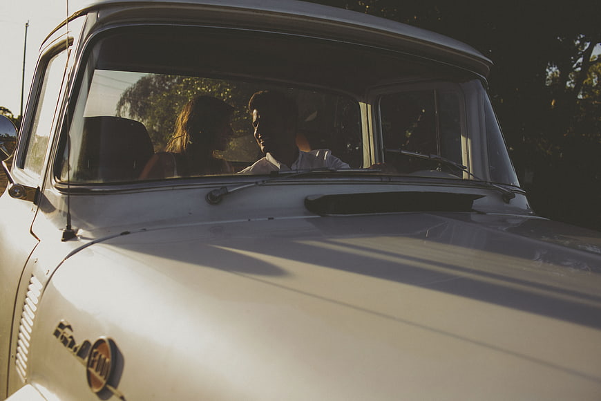 Couple in Vintage Car at Golden Hour