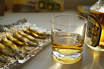Glass of Whisky and Grilled Fish on Foil