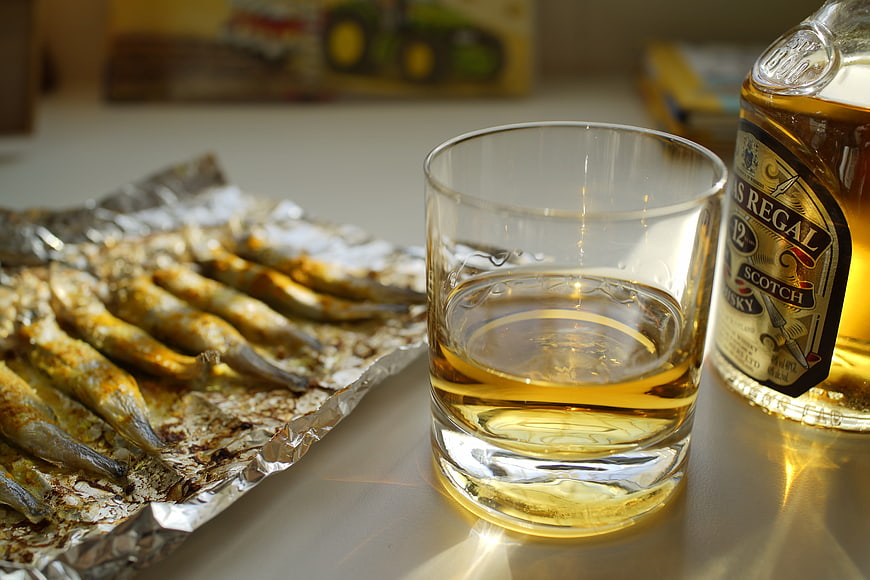 Glass of Whisky and Grilled Fish on Foil
