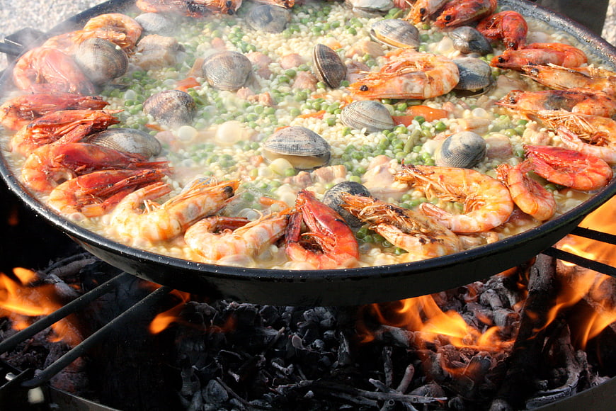 Traditional Spanish Seafood Paella Cooking Over Open Fire