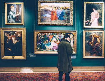 Man Viewing Pre-Raphaelite Paintings in Museum Gallery