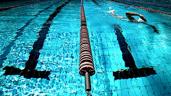 Swimmer in Pool Lane with Blue Water Ripples