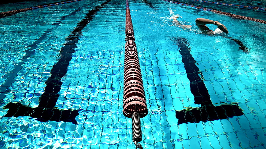 Swimmer in Pool Lane with Blue Water Ripples