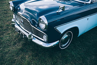 Vintage Blue and White Classic Car on Grass
