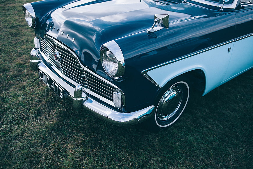 Vintage Blue and White Classic Car on Grass