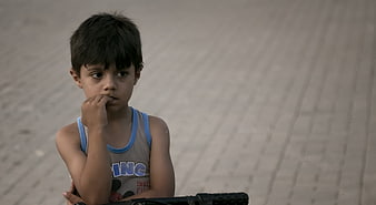 Portrait of a young boy sitting on a bicycle outdoors