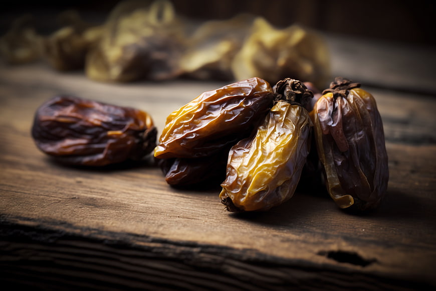 Close-up of dried dates on rustic wooden table