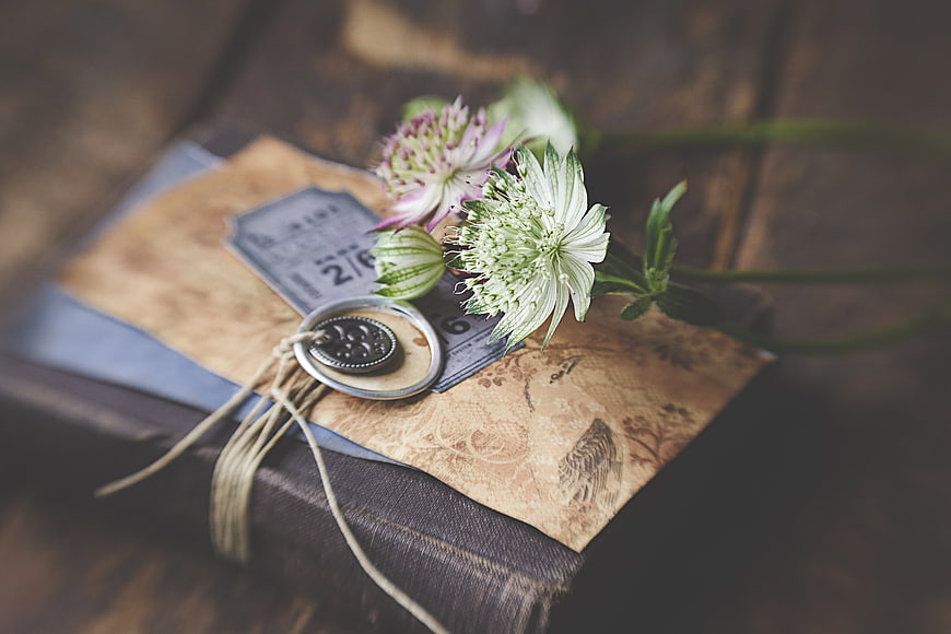Vintage Book with Flowers and Wax Seal on Wooden Table