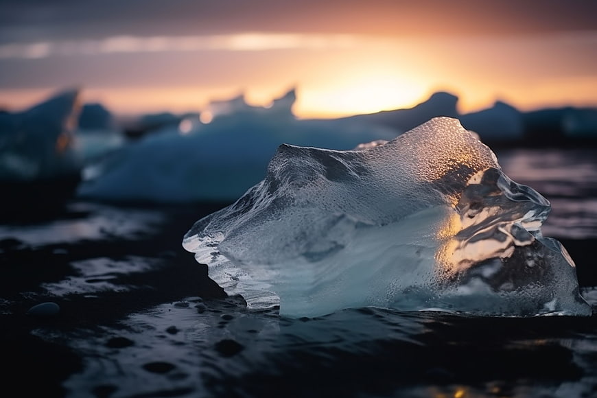 Glowing Iceberg on Black Sand Beach at Sunset