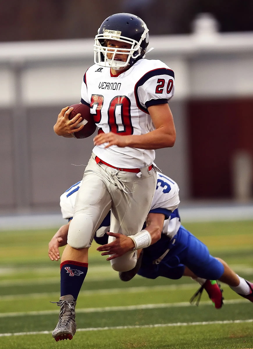 American Football Player Running with Ball During Game