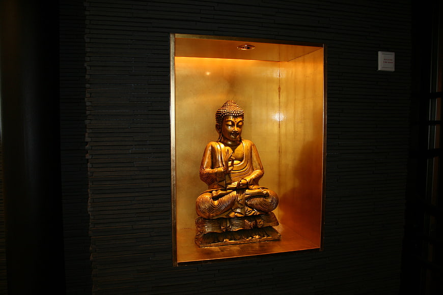 Golden Buddha Statue in Illuminated Niche