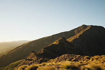 Golden Hour Mountain Ridge Landscape with Hiker Silhouette