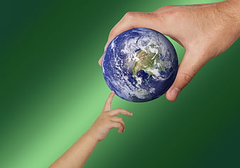 Adult and child hands holding globe on green background