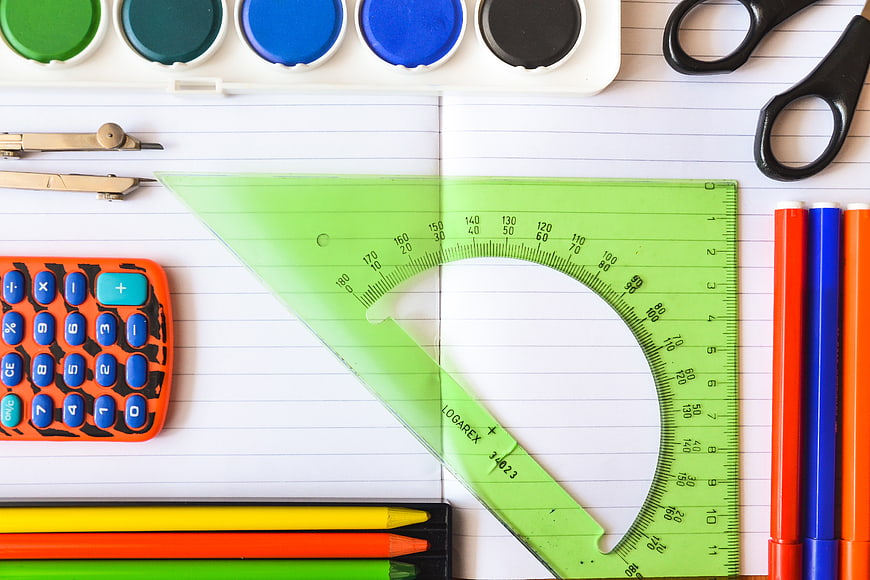Top View of Colorful School Supplies on Lined Notebook