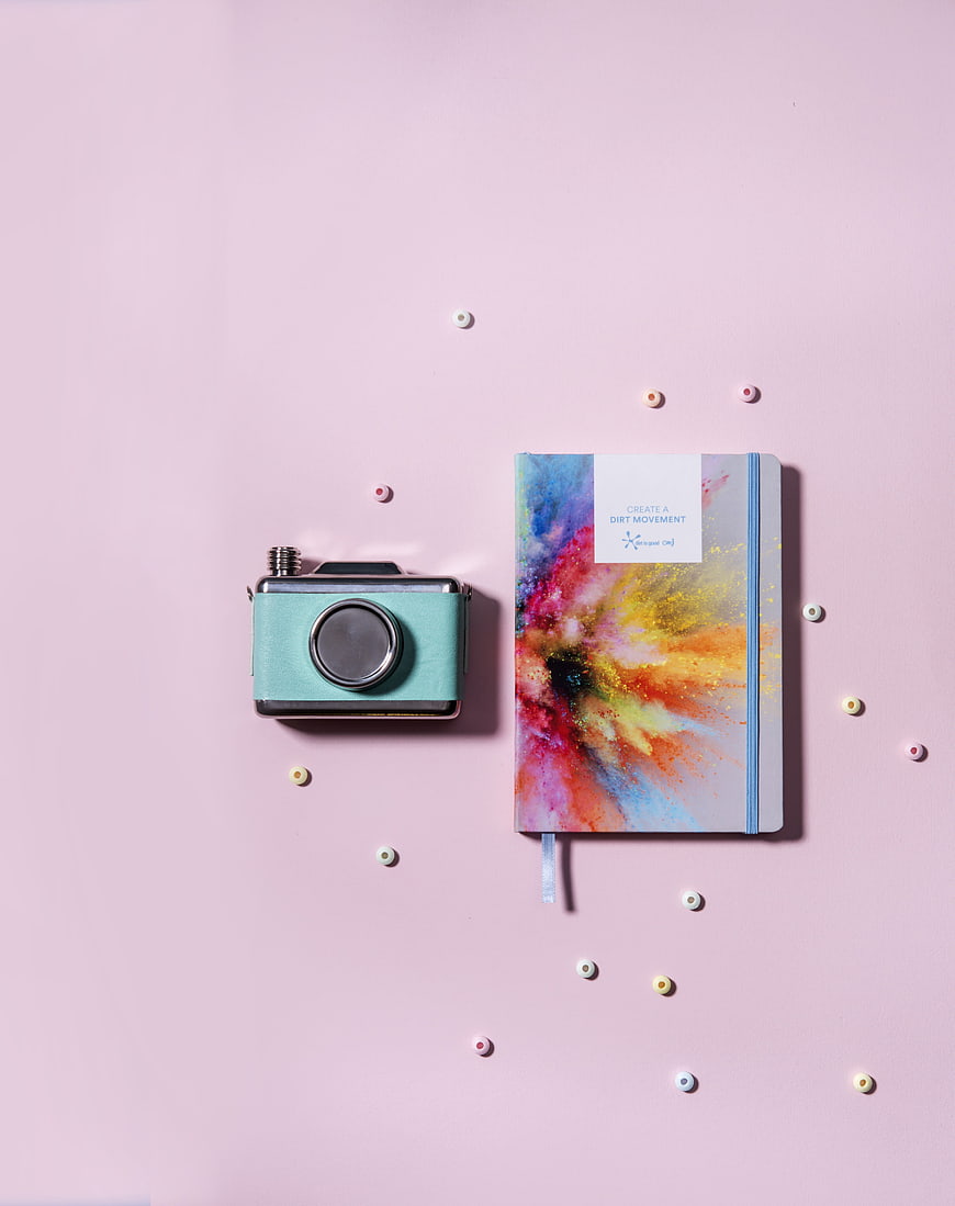 Pastel Flat Lay With Vintage Camera And Colorful Journal