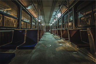 Empty subway car interior at night with blue seats