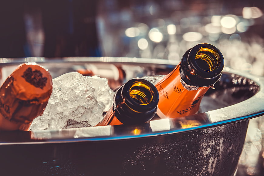 Champagne bottles chilling in ice bucket with condensation