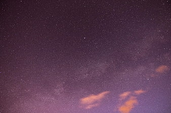 Purple Starry Night Sky with Milky Way and Clouds