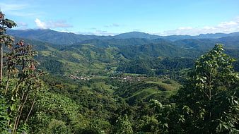 Panoramic View of Lush Green Mountain Valley with Village