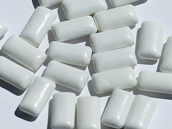 White rectangular chewing gum pieces on white background