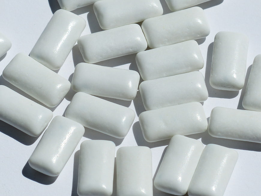 White rectangular chewing gum pieces on white background