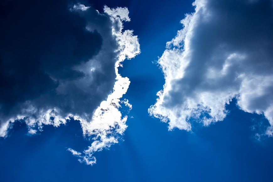Dramatic Blue Sky With White Clouds And Sun Rays