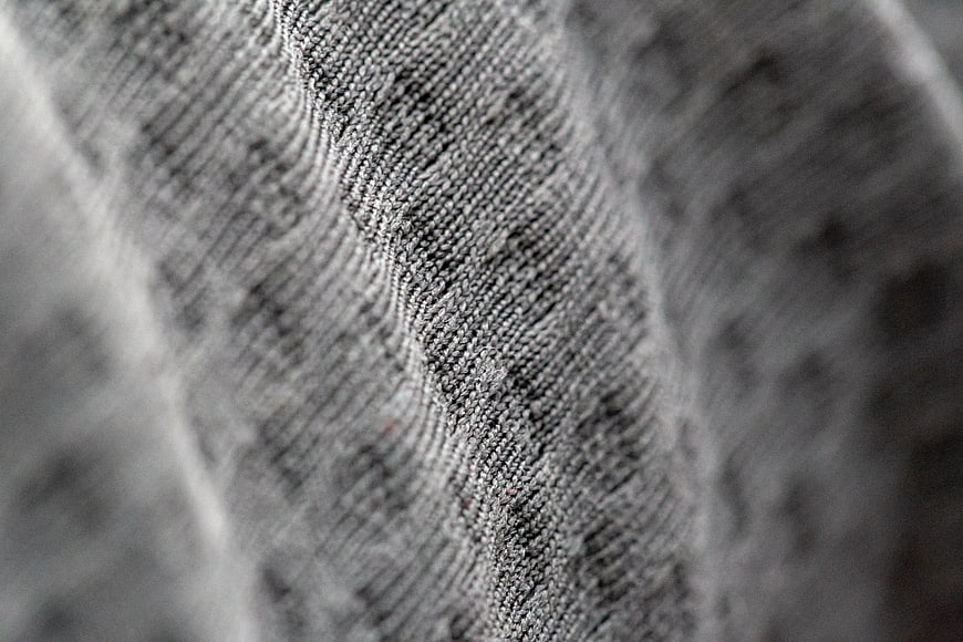 Close-up of gray knitted fabric texture with wavy pattern