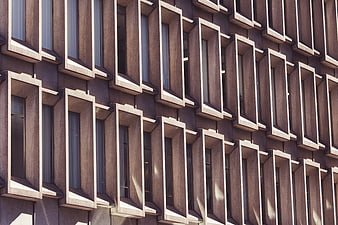 Modern Concrete Building Facade with Geometric Window Pattern